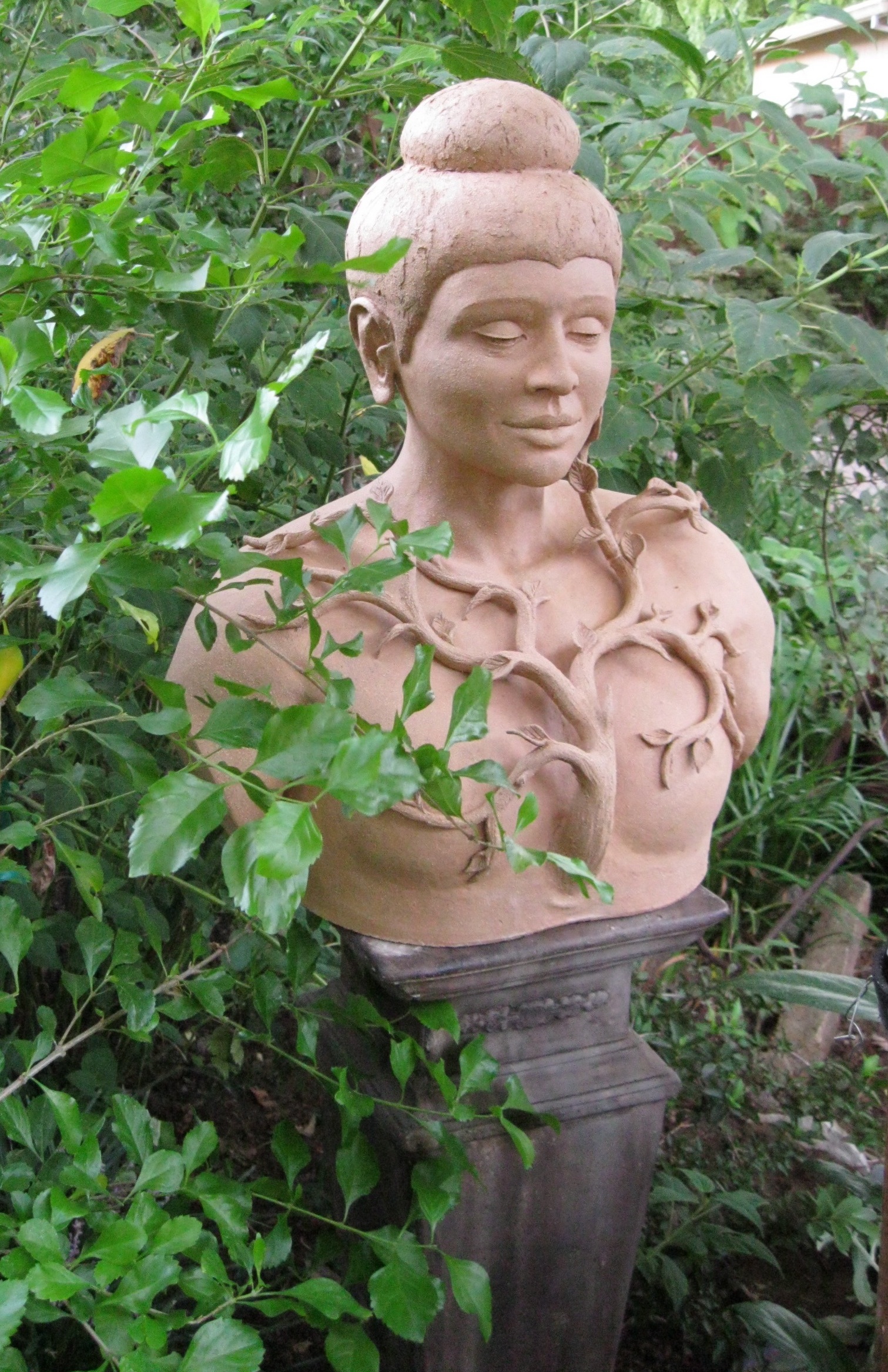 Ceramic Sculpture of Meditative Figure in Garden